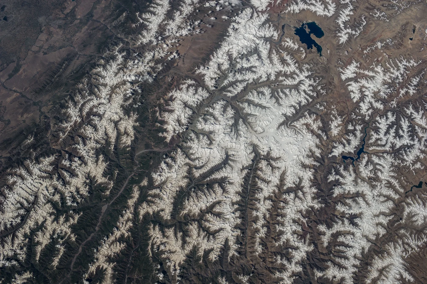 Satellite view of snow-covered mountain ranges