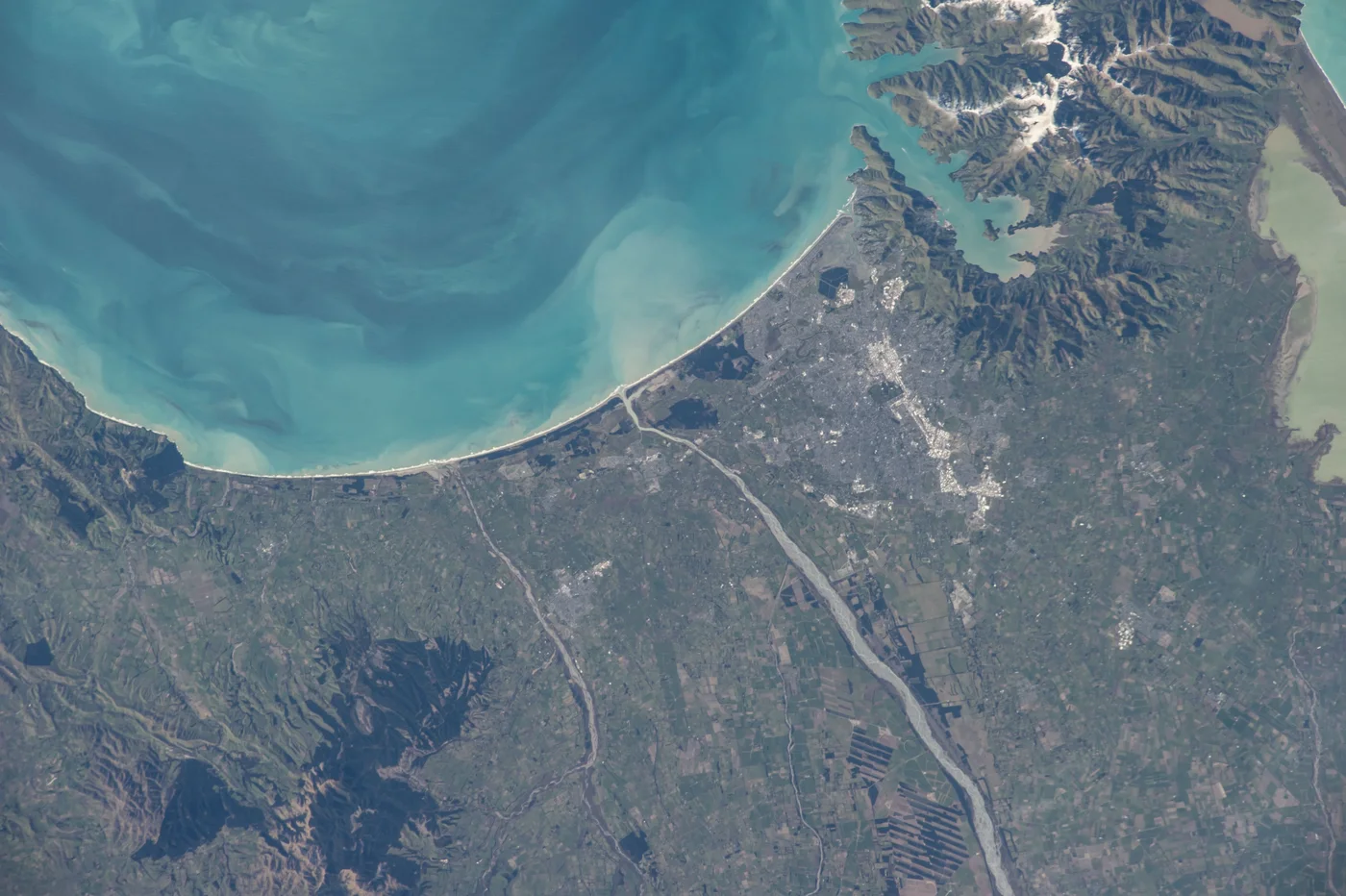 Satellite view of a coastal city and turquoise sea